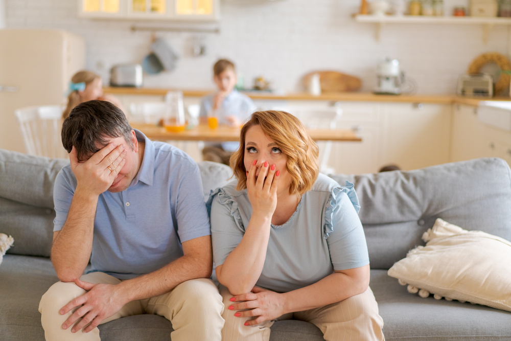 Tense Parents Sitting on Sofa Tired Crazy Loud Hyperactive Little Kids